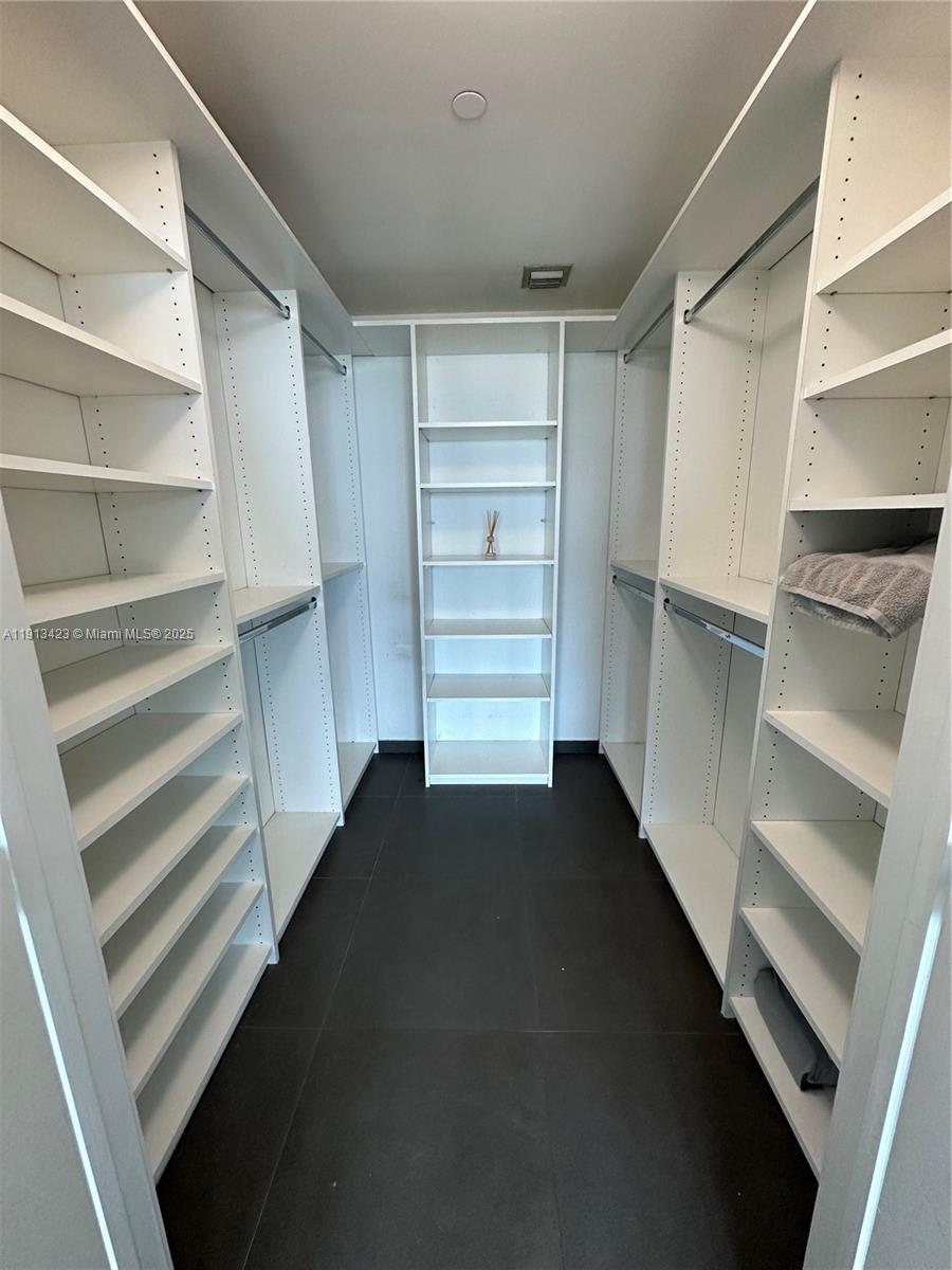 888 Biscayne Boulevard, Unit 4302 Miami, FL 33132 - Photo 4 of 6 a view of walk in closet with empty racks