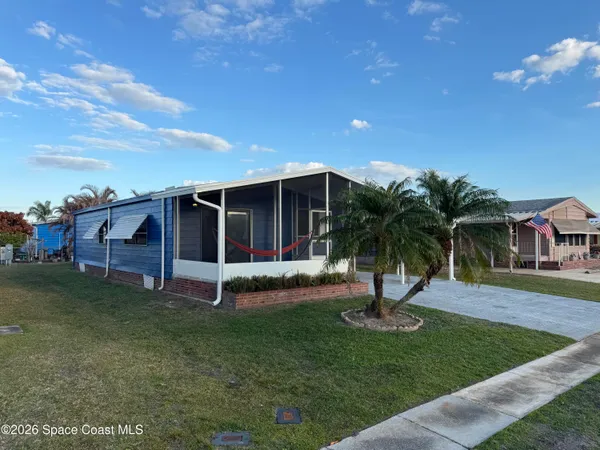 a view of a house with swimming pool and a yard