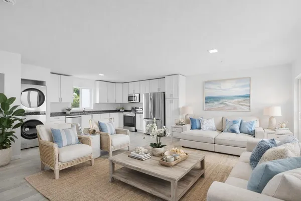 a large kitchen with stainless steel appliances granite countertop a stove a sink and a refrigerator