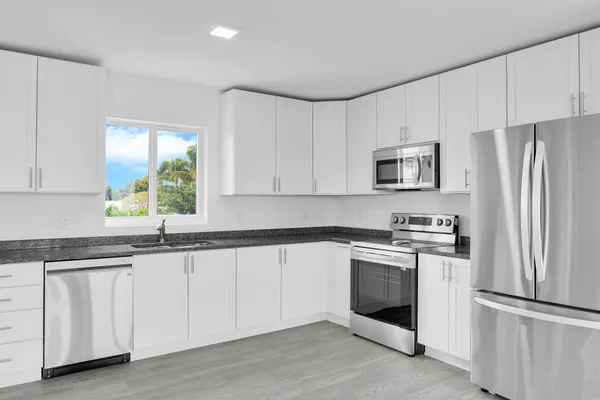 a kitchen with a stove top oven sink and cabinets