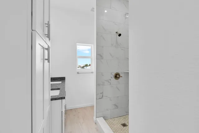 a view of a kitchen with a sink and dishwasher a refrigerator with wooden floor