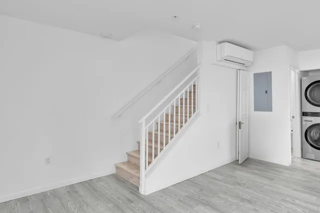 a view of a kitchen with wooden floor and windows