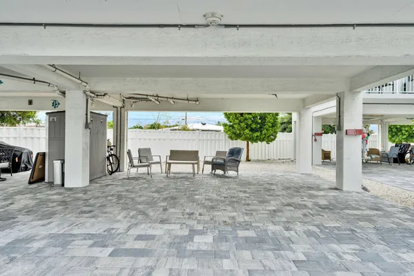 a view of an ocean with boats and trees in the background