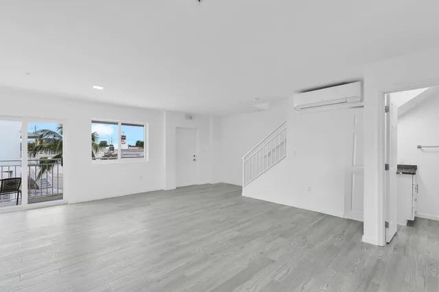 a kitchen with white cabinets and washer