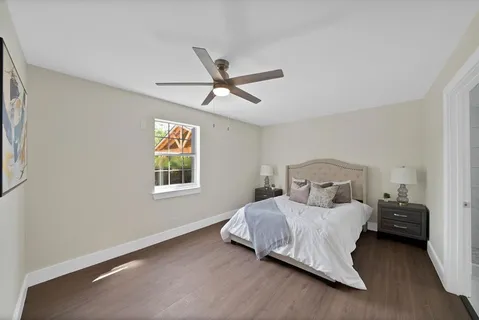 a bedroom with a bed and a window