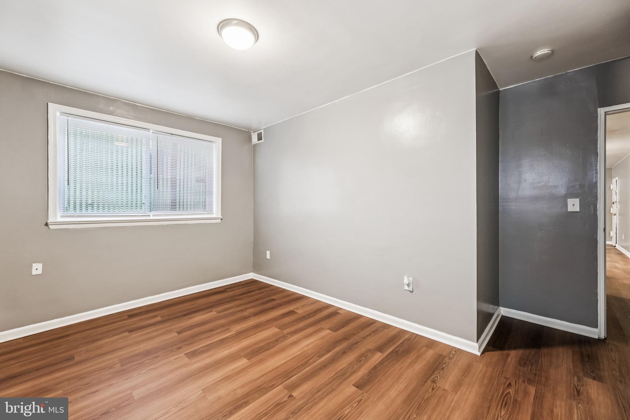 2640 Wade Road Southeast, Unit 2 Washington, DC 20020 - Photo 4 of 23 a view of an empty room with wooden floor and a window