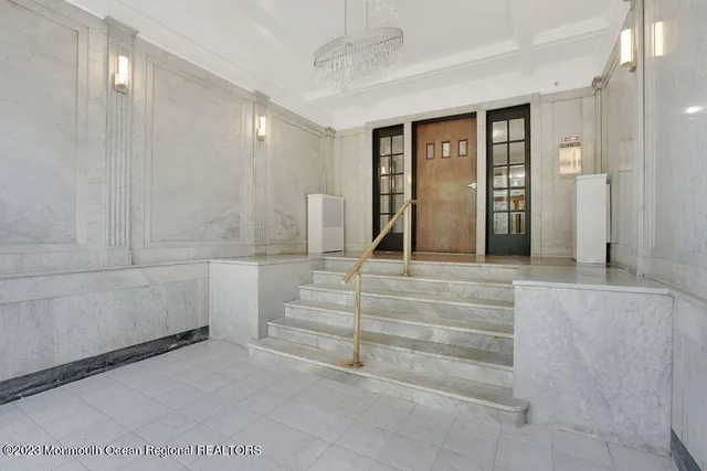 a bathroom with a granite countertop sink a mirror and a shower