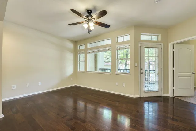 a kitchen with stainless steel appliances granite countertop a refrigerator a sink a stove a microwave and wooden cabinets