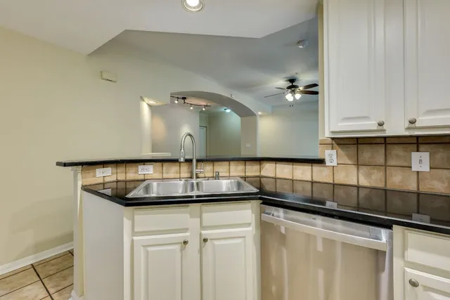 a kitchen with stainless steel appliances granite countertop a sink and a stove
