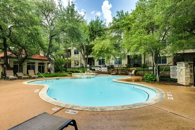 a view of a balcony with wooden floor and fence
