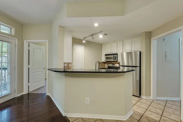 a view of a kitchen with wooden floor and a kitchen