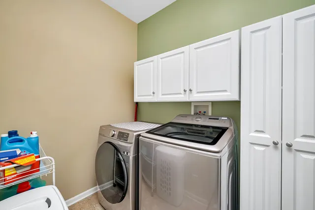 a bathroom with a tub a sink and a large mirror