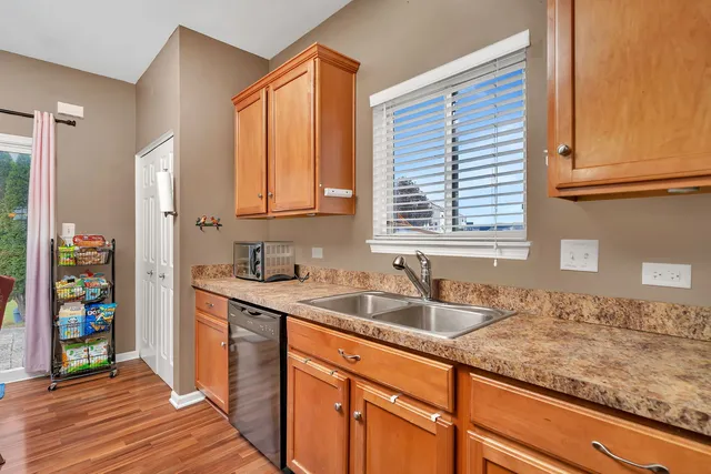 a kitchen with wooden floors and appliances