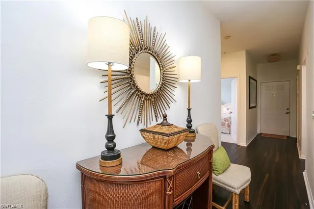 a kitchen with a refrigerator stove and wooden floor