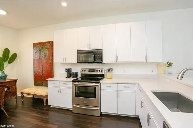 a kitchen with a sink appliances and cabinets