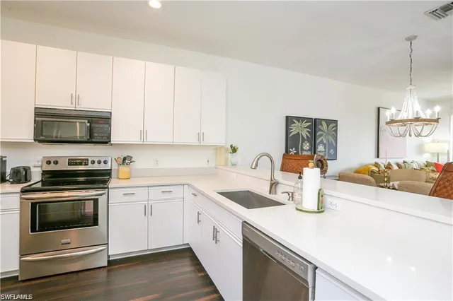 a kitchen with a sink a stove and microwave