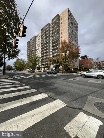 a city street lined with buildings and trees