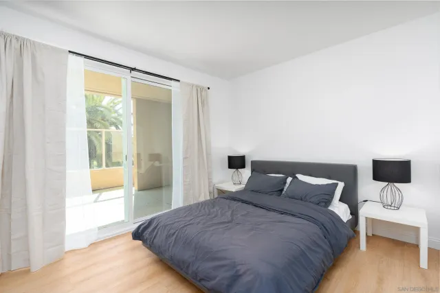 a bedroom with a bed and large window