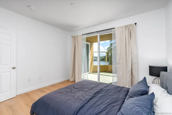 a bedroom with a bed and a large window