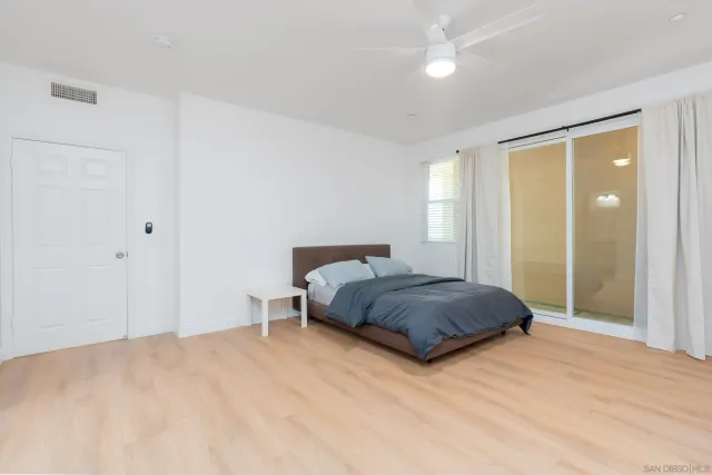 a bedroom with a bed and a night stand