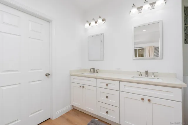 a bathroom with a sink vanity and mirror