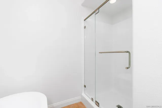 a bathroom with a toilet and a shower