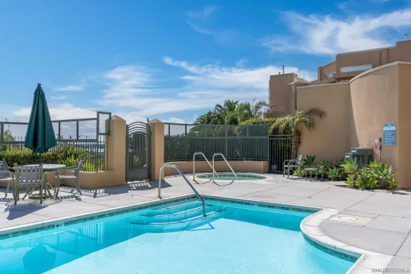 a view of a swimming pool with outdoor seating