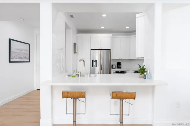 a kitchen with stainless steel appliances a refrigerator and a stove top oven