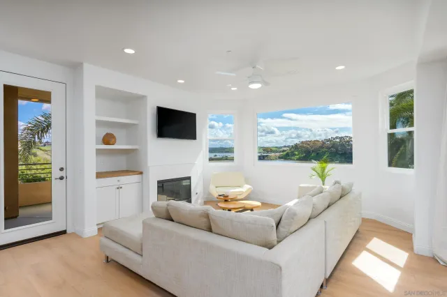 a living room with furniture fireplace and flat screen tv