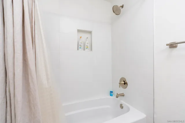 a bathroom with bathtub and shower