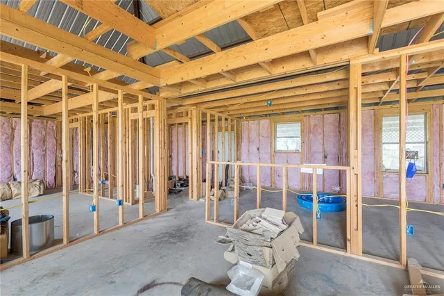 a living room with furniture and floor to ceiling window