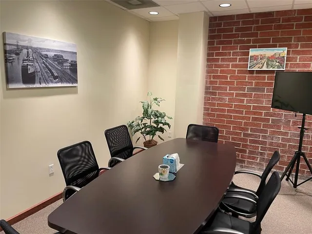 a kitchen with refrigerator and chairs