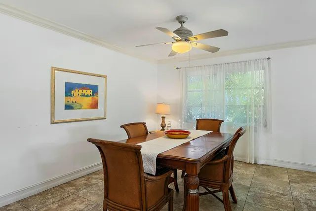 a view of a dining room with a table and chairs