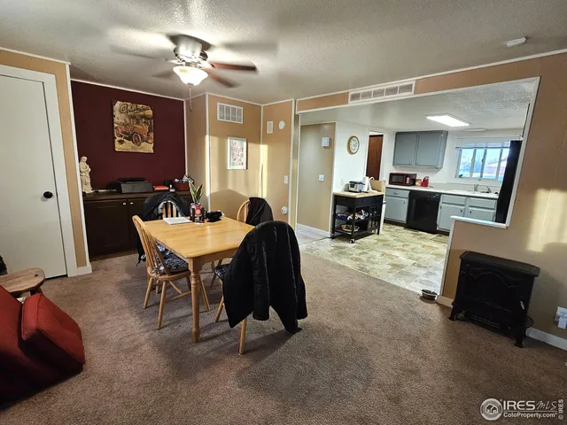 a living room with furniture a fireplace and paintings on the wall