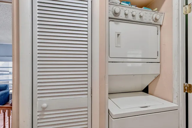 a dining room with furniture and a floor to ceiling window