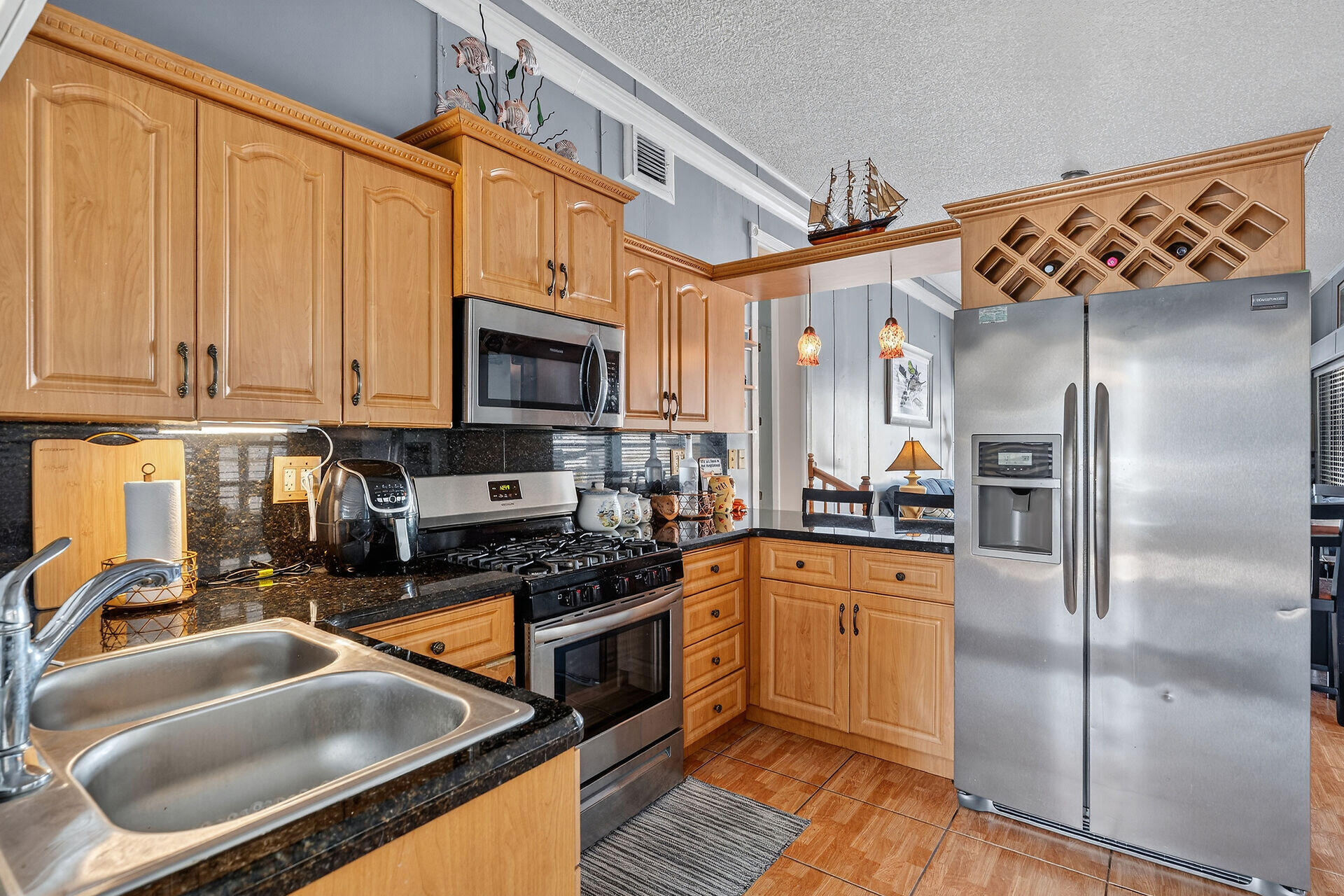 65821 Overseas Highway, Unit 112 Long Key, FL 33001 - Photo 41 of 49 a kitchen with stainless steel appliances granite countertop a refrigerator a stove top oven a sink and dishwasher
