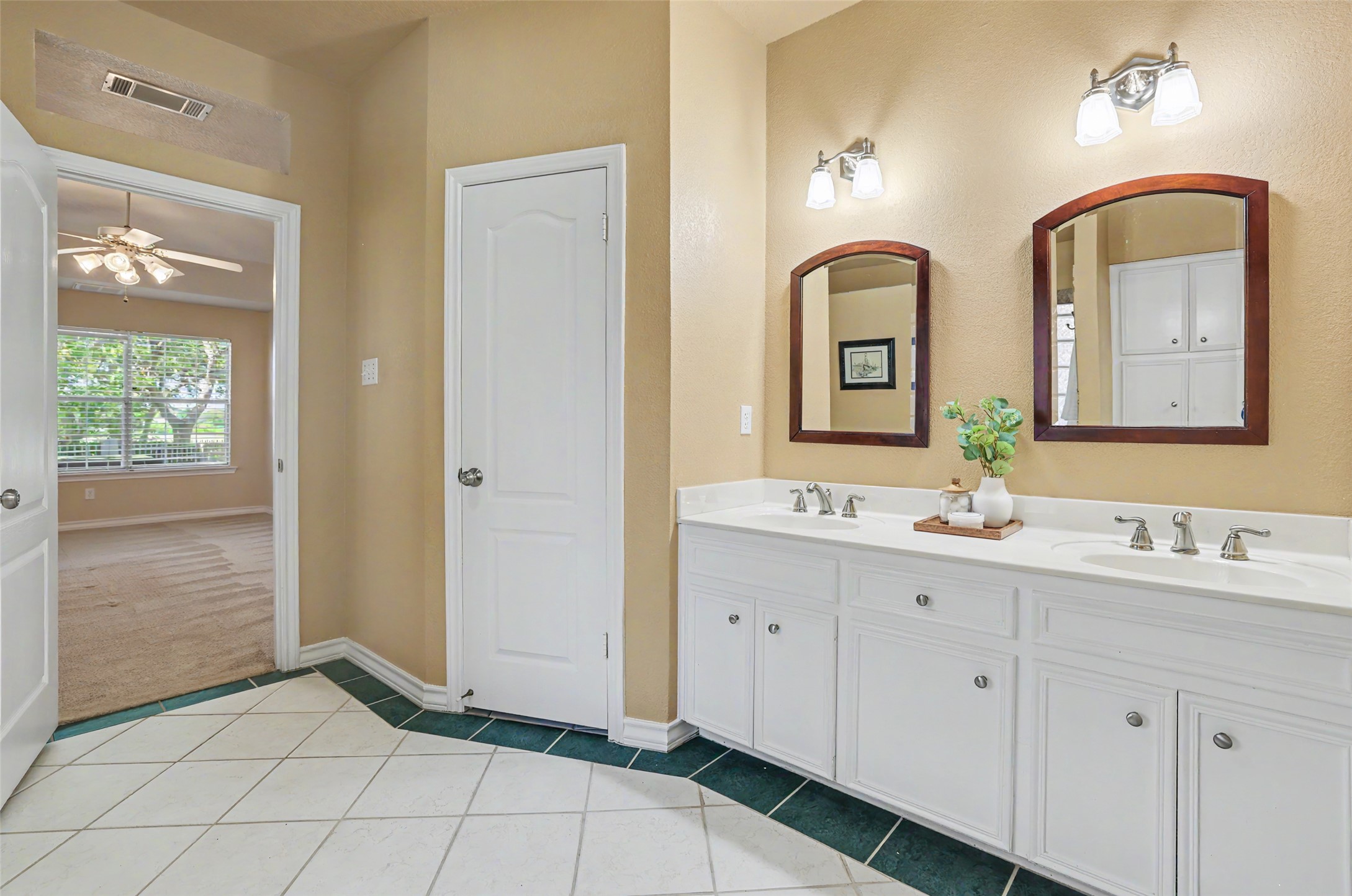 30107 Hamlet Circle Georgetown, TX 78628 - Photo 18 of 40 A well-lit primary bathroom vanity provides abundant storage and dual basins.