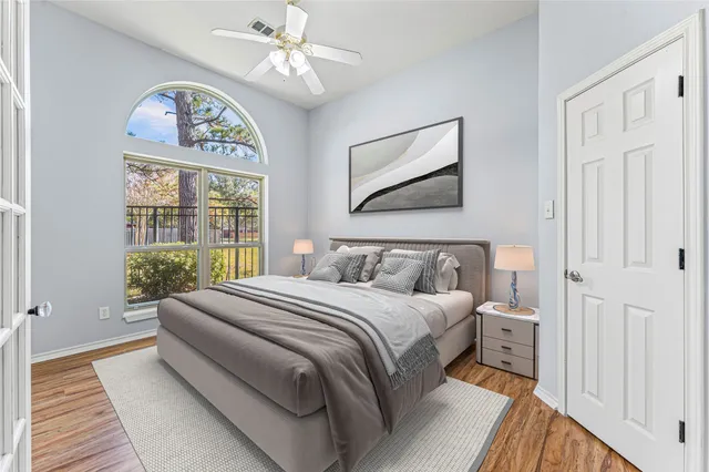a bedroom with a large bed and a chandelier