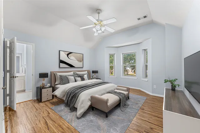 a bedroom with a bed and a large mirror