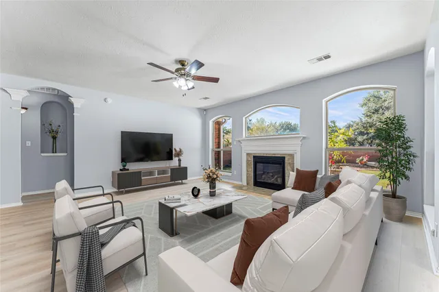 a living room with furniture a fireplace and a flat screen tv