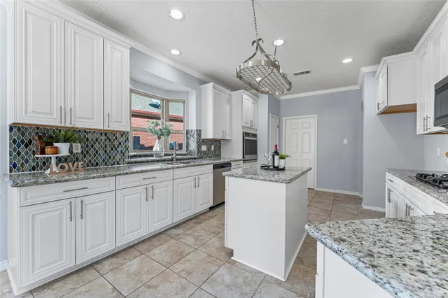 a kitchen with a sink counter top space cabinets and appliances