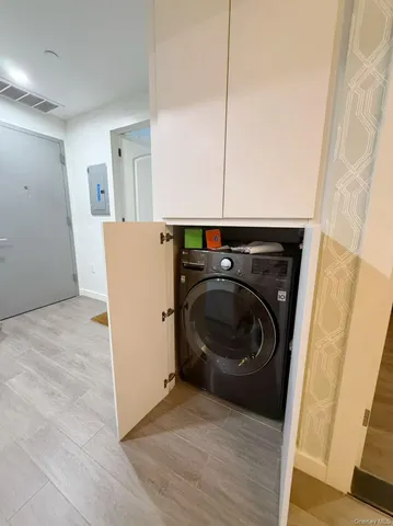 a view of a storage and utility room with washer and dryer