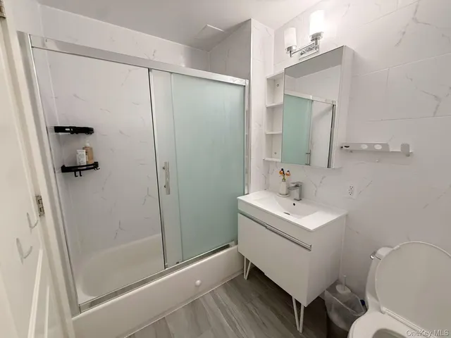 a bathroom with a sink toilet and shower