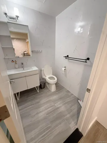 a bathroom with a sink a toilet and mirror