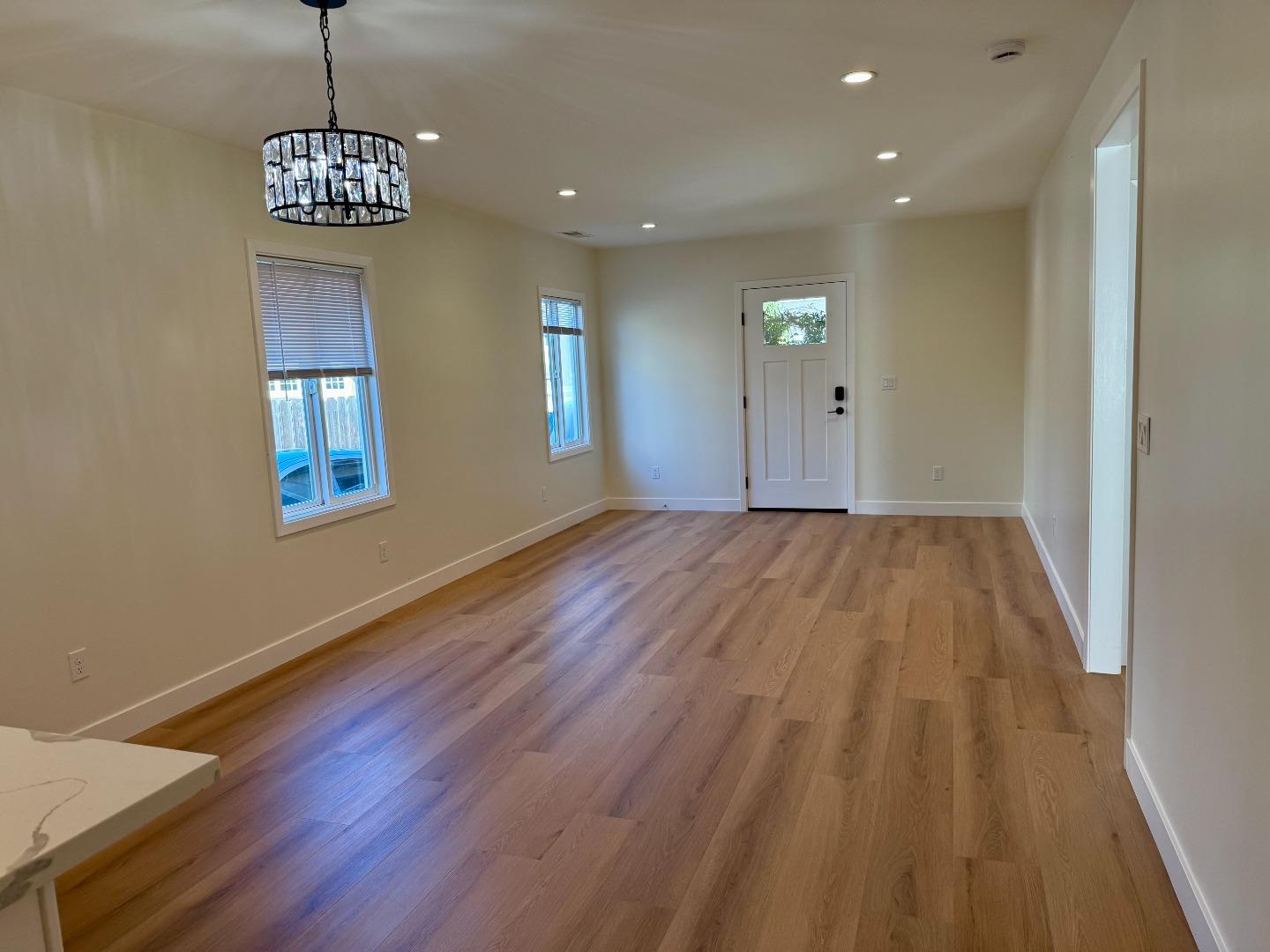 634 Fulton Street Redwood City, CA 94061 - Photo 14 of 24 a view of an empty room with window and wooden floor