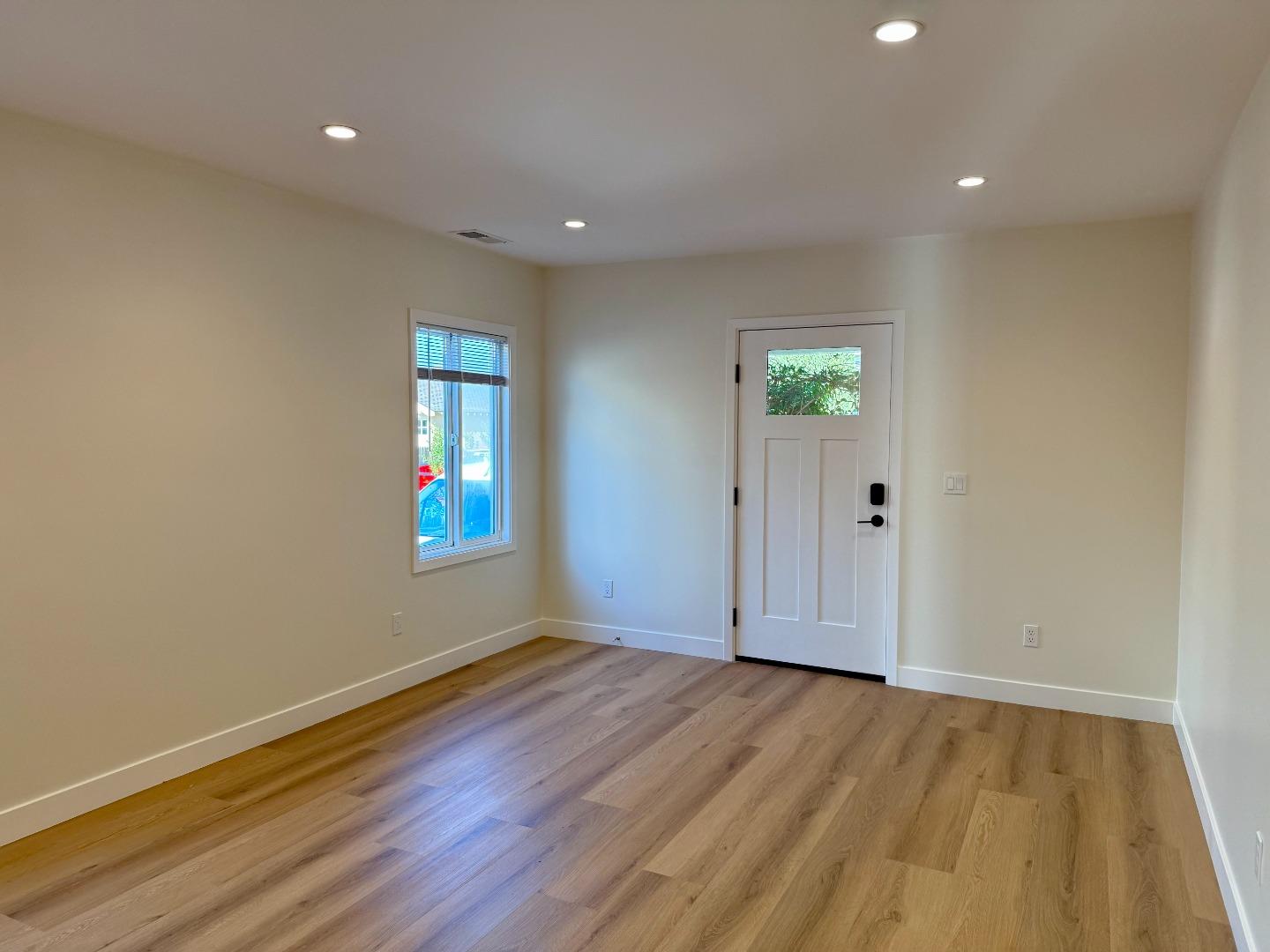 634 Fulton Street Redwood City, CA 94061 - Photo 15 of 24 a view of an empty room with wooden floor and a window
