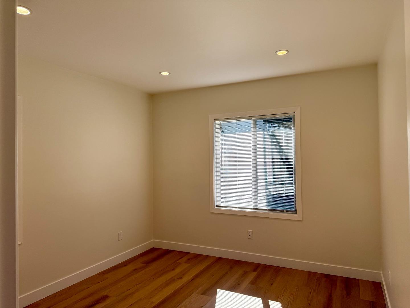 634 Fulton Street Redwood City, CA 94061 - Photo 16 of 24 a view of empty room with wooden floor and fan