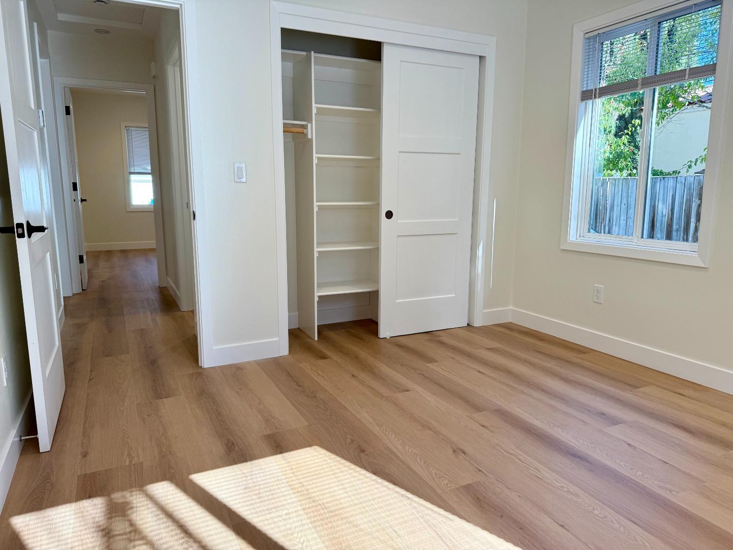 634 Fulton Street Redwood City, CA 94061 - Photo 17 of 24 an empty room with wooden floor and windows