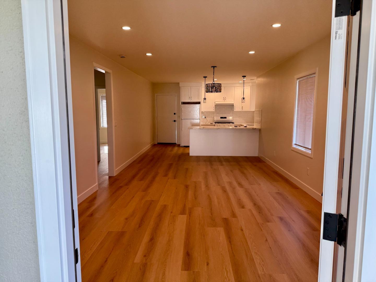 634 Fulton Street Redwood City, CA 94061 - Photo 7 of 24 a large kitchen with a sink and wooden floor
