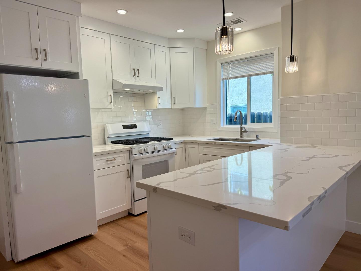 634 Fulton Street Redwood City, CA 94061 - Photo 10 of 24 a kitchen with white cabinets and white appliances